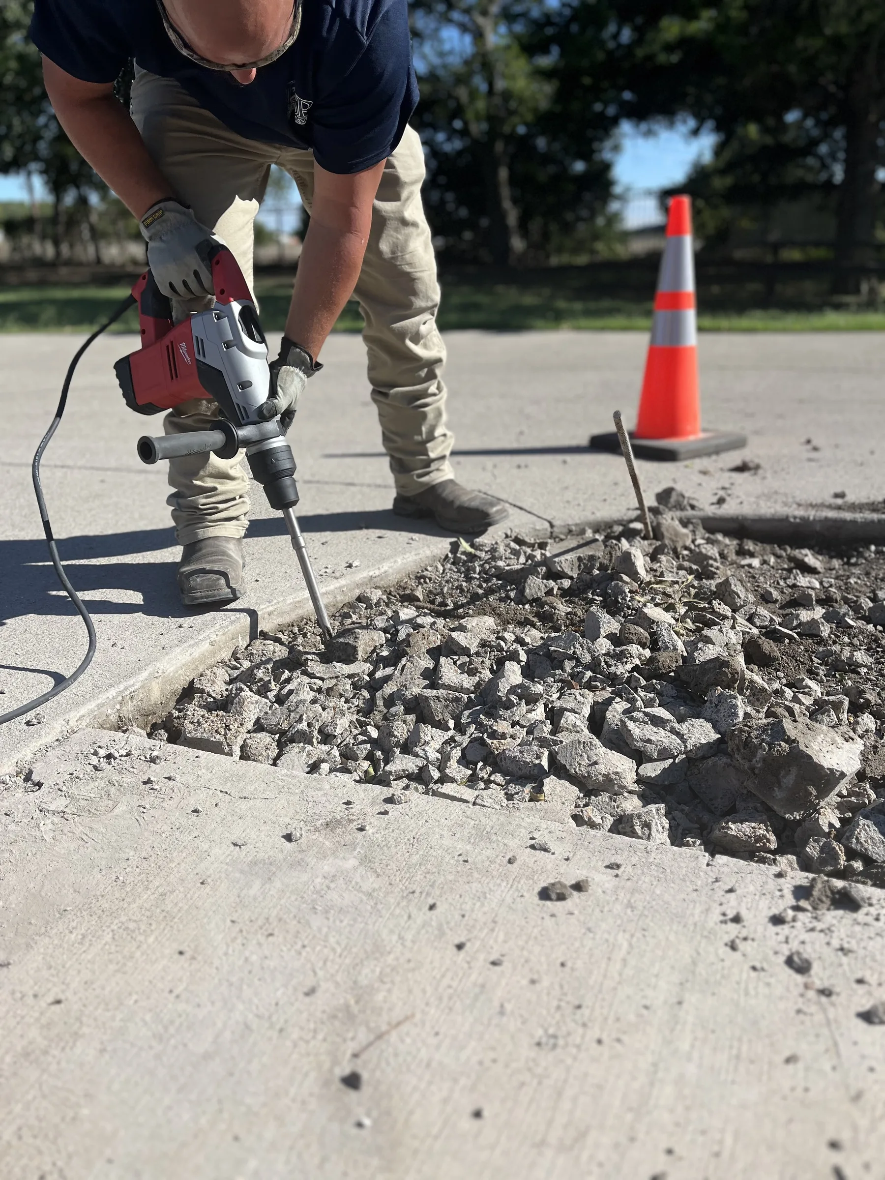 LSR technician performing concrete demolition with rotary hammer